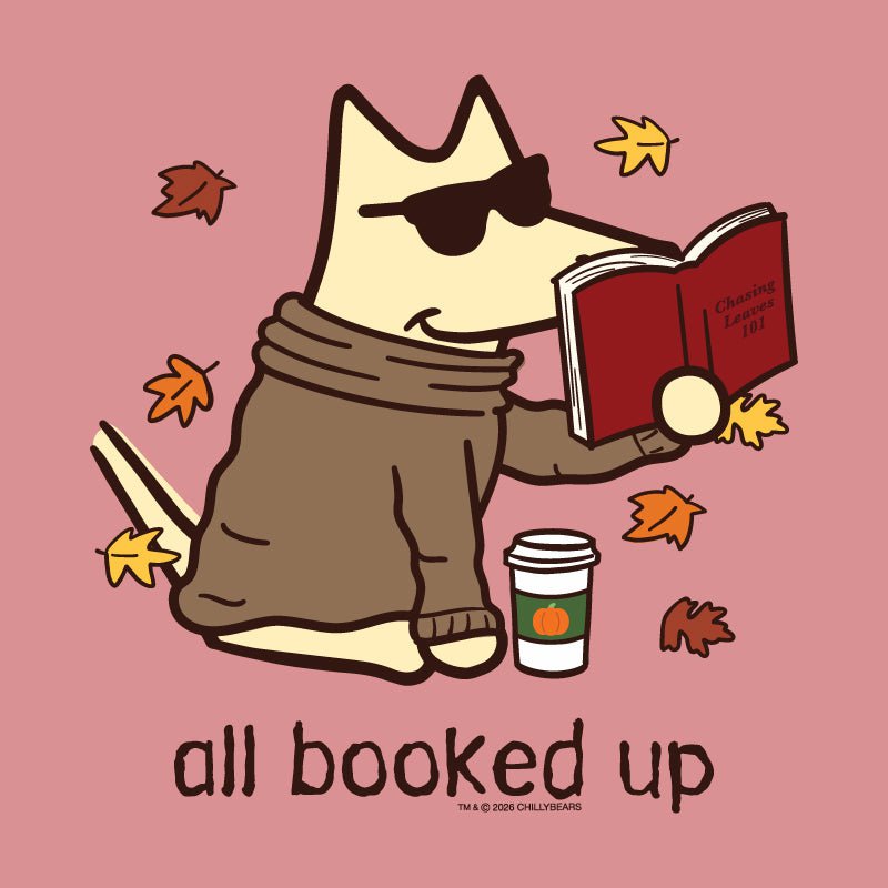 A stylized cartoon dog wearing dark sunglasses and a brown sweater sits on a dusty pink background, reading a red book with autumn leaves floating around it. A takeaway coffee cup appears beside the dog, and the text 'all booked up' appears below.
