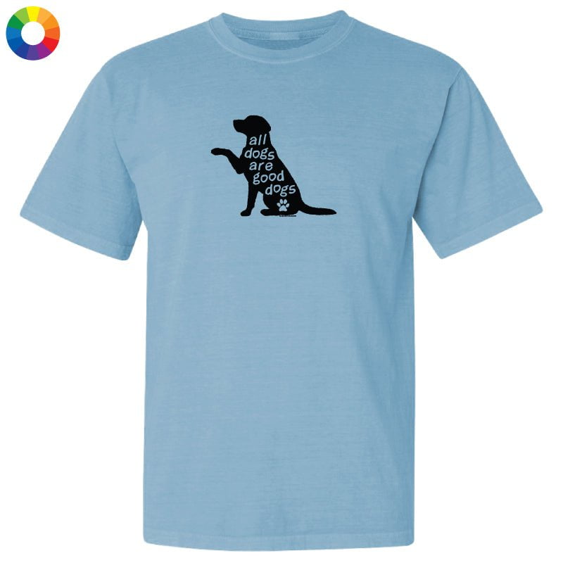 A light blue short-sleeve crewneck t-shirt featuring a black graphic of a sitting dog silhouette with the text 'all dogs are good dogs' and a small paw print.