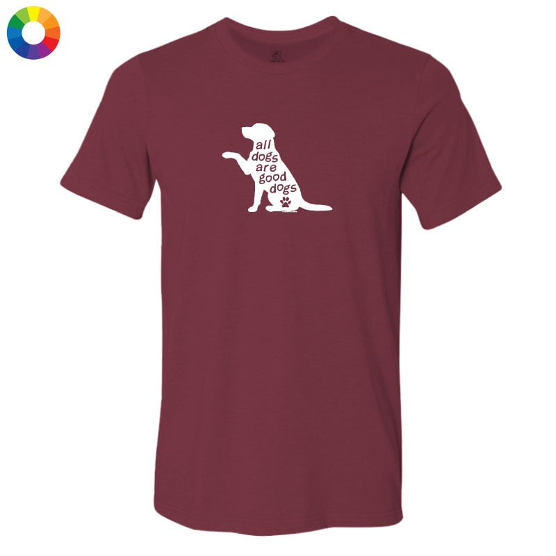 A maroon short-sleeve crewneck t-shirt with a white graphic of a dog silhouette containing the text 'all dogs are good dogs' and a small paw print. A multicolor color wheel icon is visible in the top-left corner.