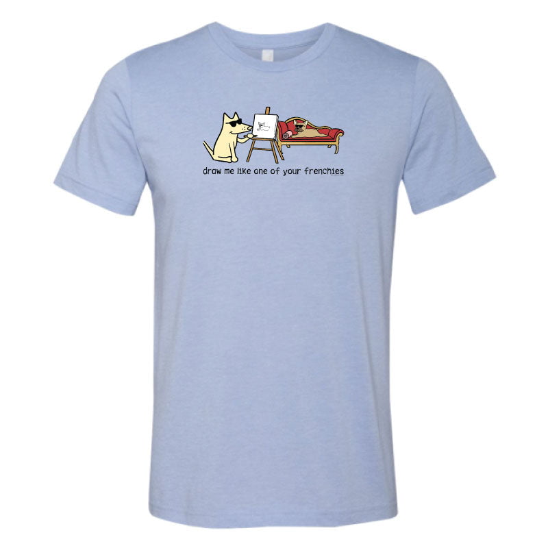 Light blue t-shirt with a graphic of a dog drawing another dog on a white background
