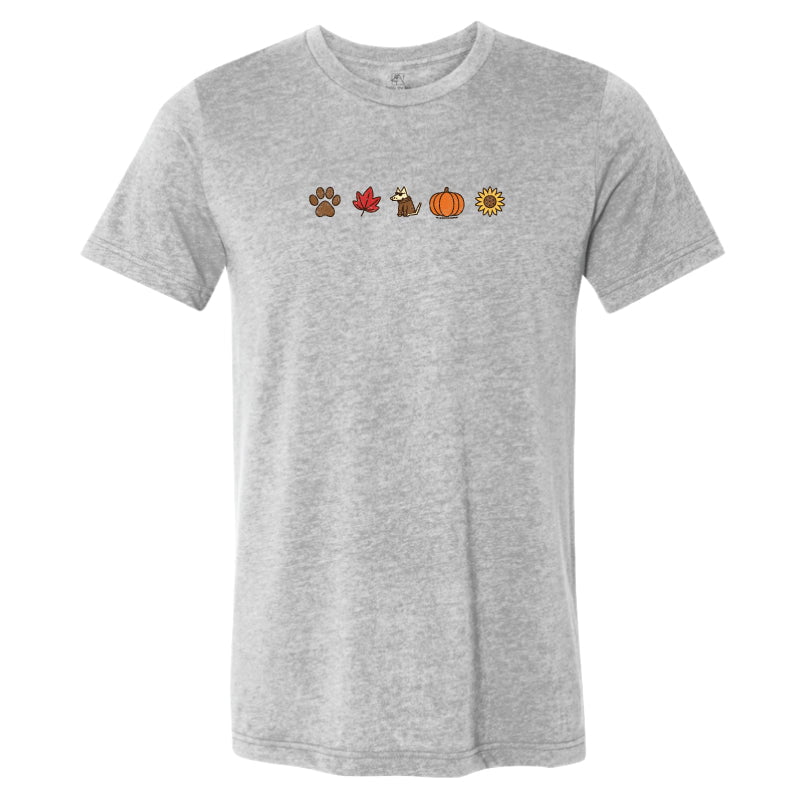 A heather gray short-sleeve crewneck t-shirt featuring a small horizontal graphic of autumn-themed icons (a paw print, a red maple leaf, a turkey, a pumpkin, and a sunflower) printed across the chest.