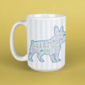 White mug with a colorful dog illustration on a yellow background