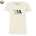 A women's short-sleeve V-neck t-shirt in a light heathered cream color, featuring a graphic of three dogs (Beagle, Labrador, and Rottweiler) with the text 'untoasted, toasted, burnt.' underneath.