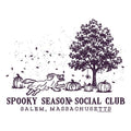 A Halloween-themed graphic print featuring a dark purple illustration of a running dog, pumpkins, a tree, and falling leaves on a white background, with the text 'SPOOKY SEASON SOCIAL CLUB' and 'SALEM, MASSACHUSETTS' below.